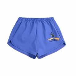 A Day At The Beach Swim Trunks by Bobo Choses